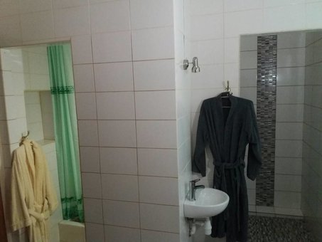 A bathroom with a shower in a standard room at the Central Park hotel in Lviv. Register for a discount.